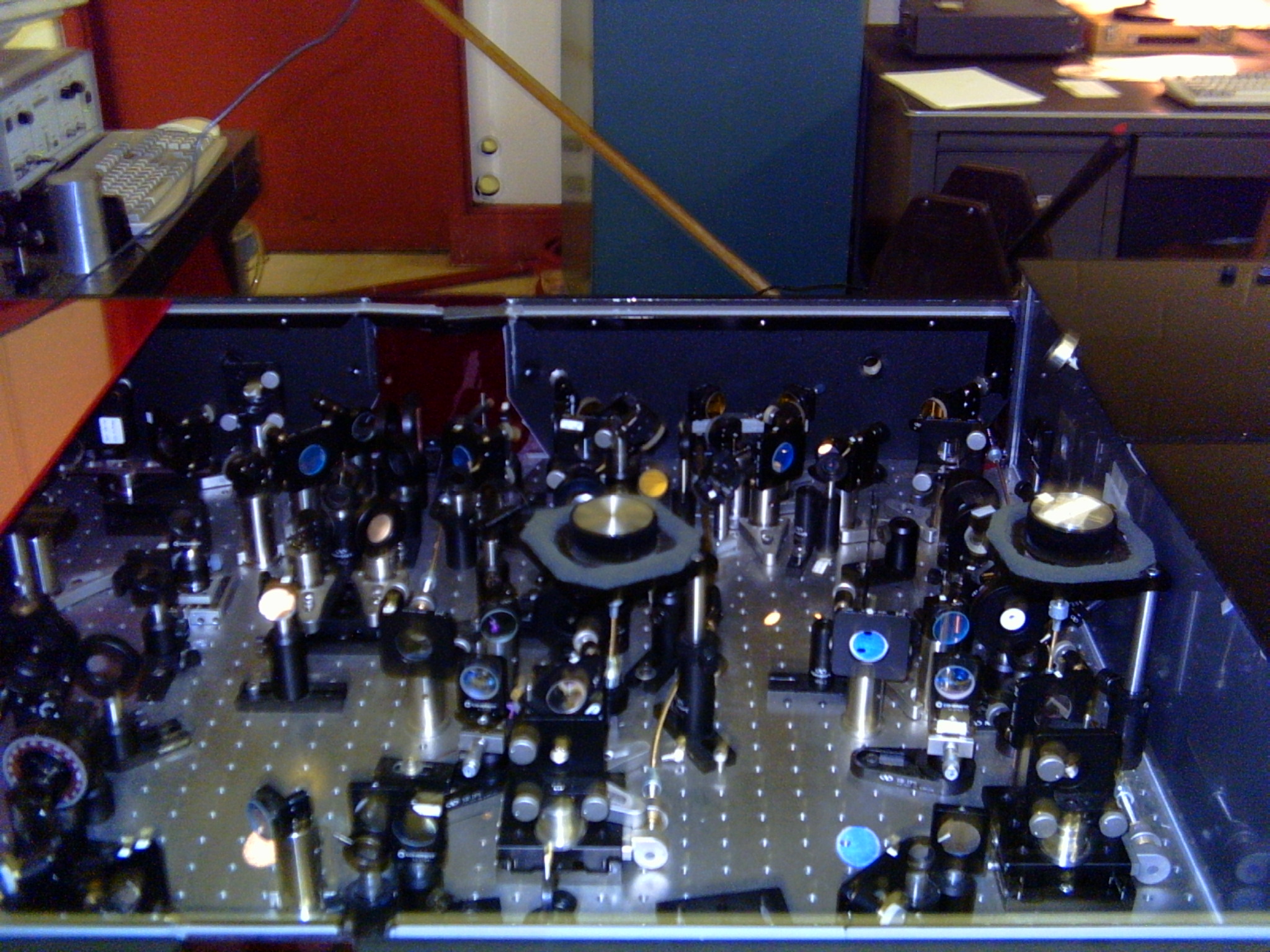 a small portion of the laser table with dozens of different mirrors and crystals.